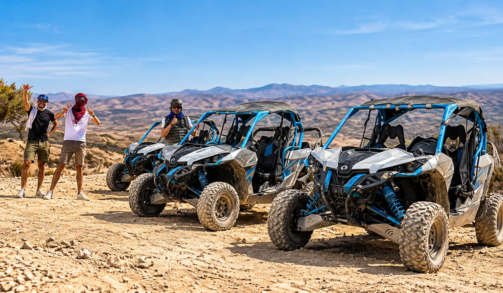 Two travellers standing beside parked blue buggies before a buggy ride in the Agafay desert hills