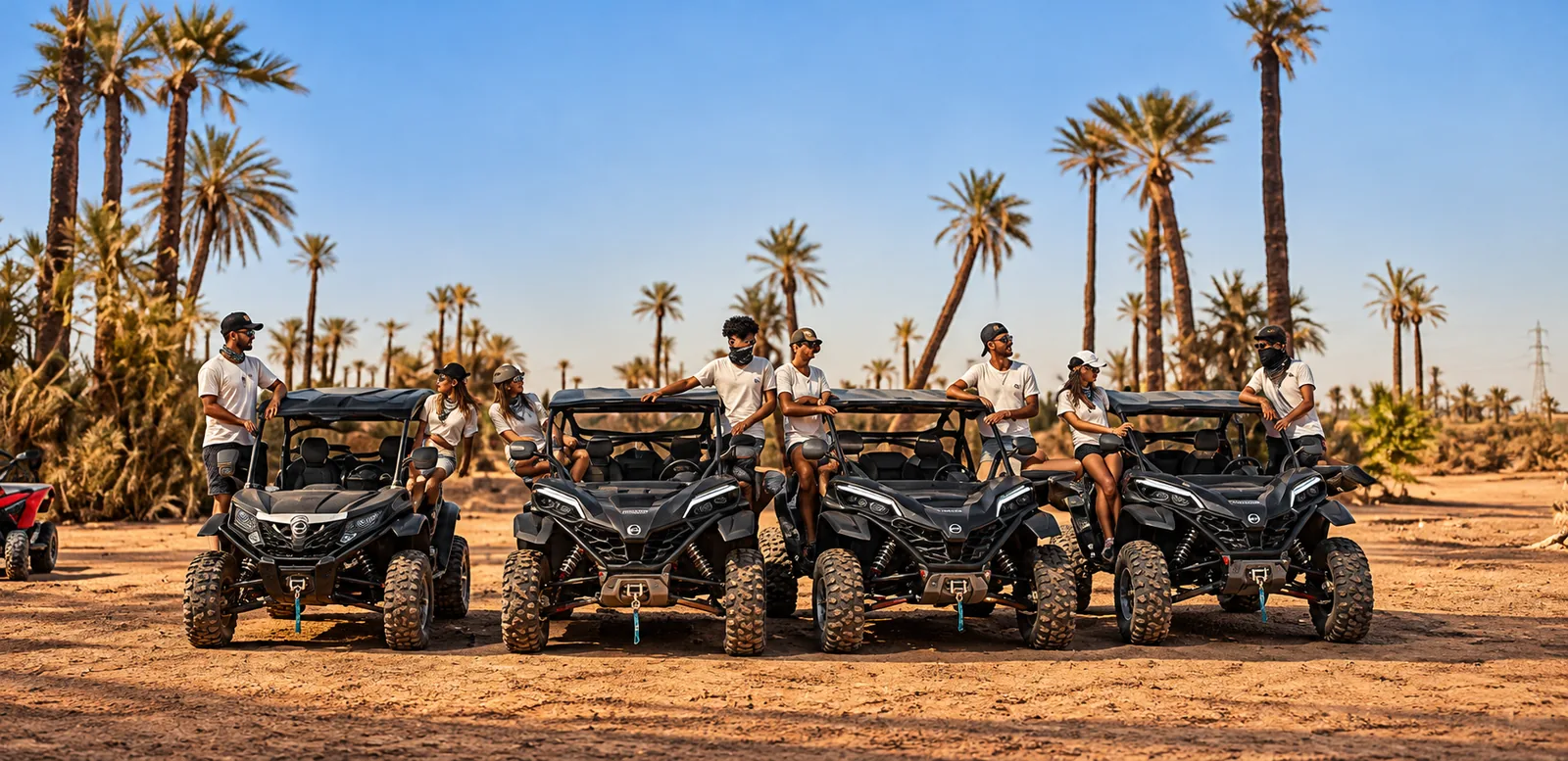 Quattro buggy neri in fila con i piloti su una pista sabbiosa, giro in buggy nella Palmeraie di Marrakech