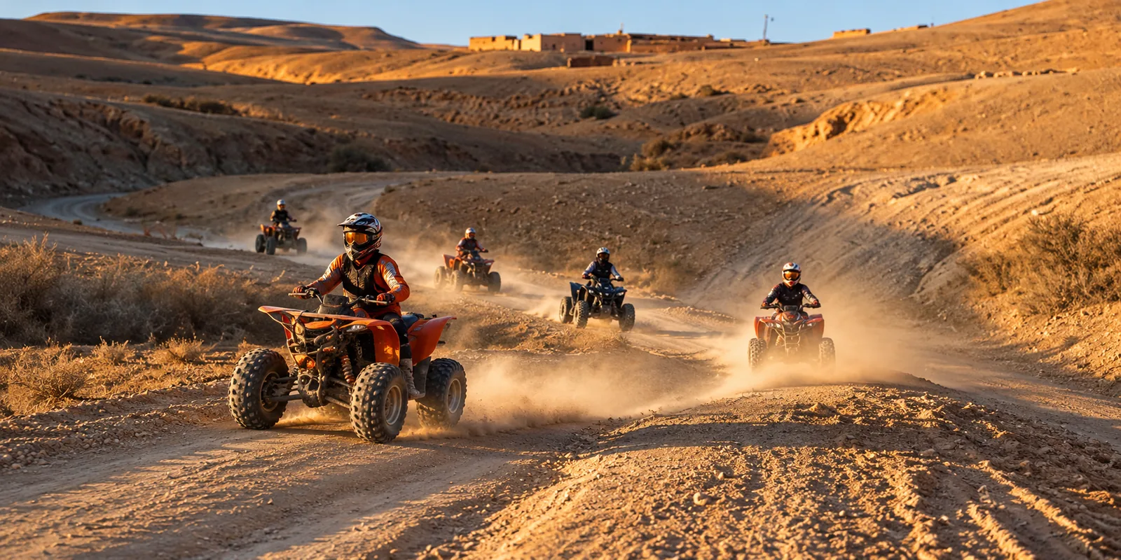 Line of quads raising dust on a winding track, quad biking in the Agafay desert hills near Marrakech