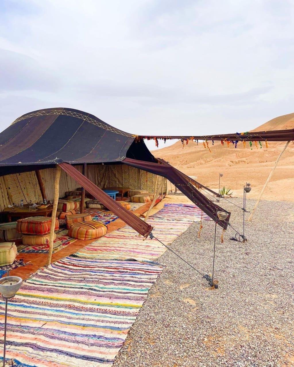 Berber tent with woven rugs at Boujemaa Agafay