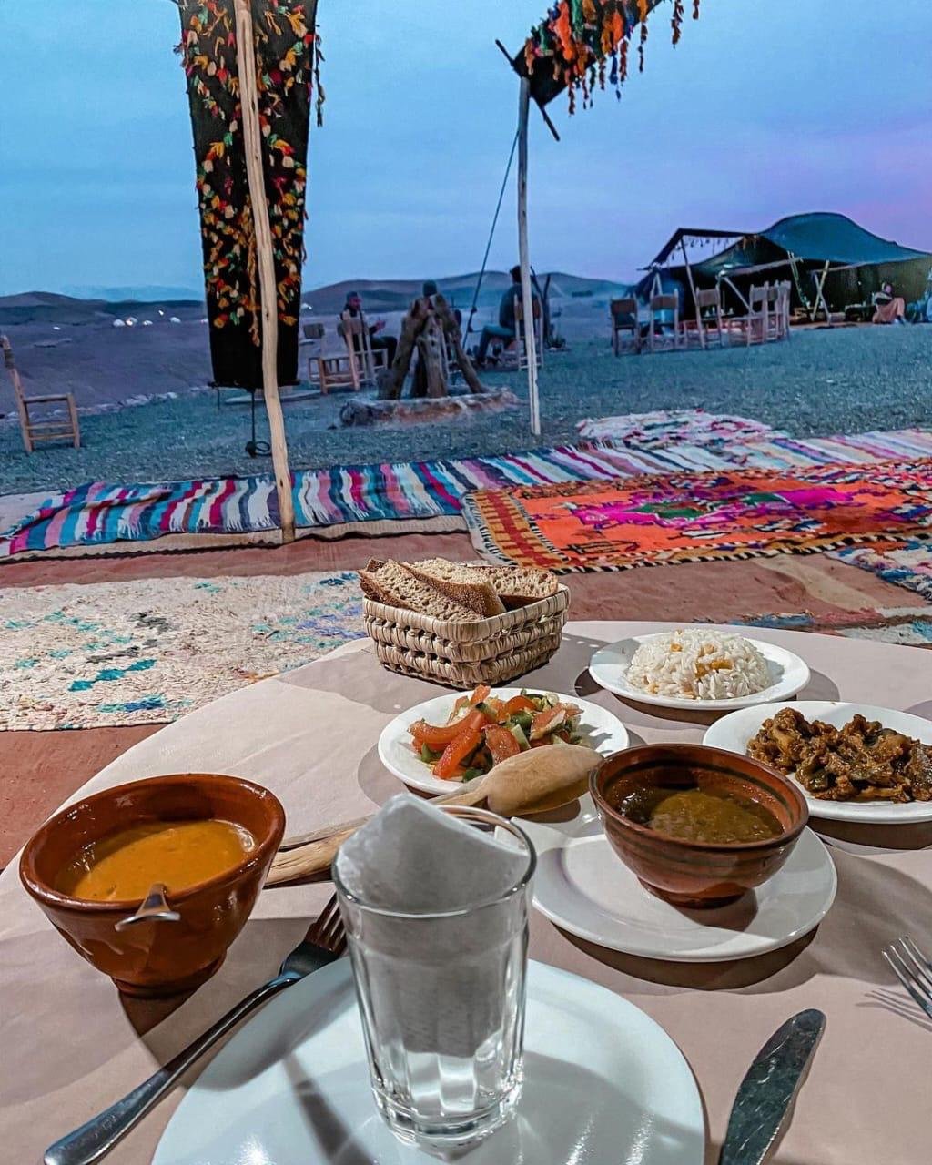 Lunch table set at the camp with the desert behind