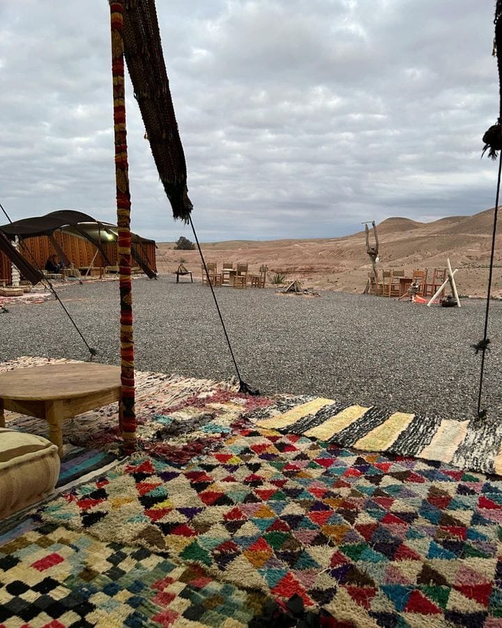 Berber tents and rugs facing the Agafay stone desert