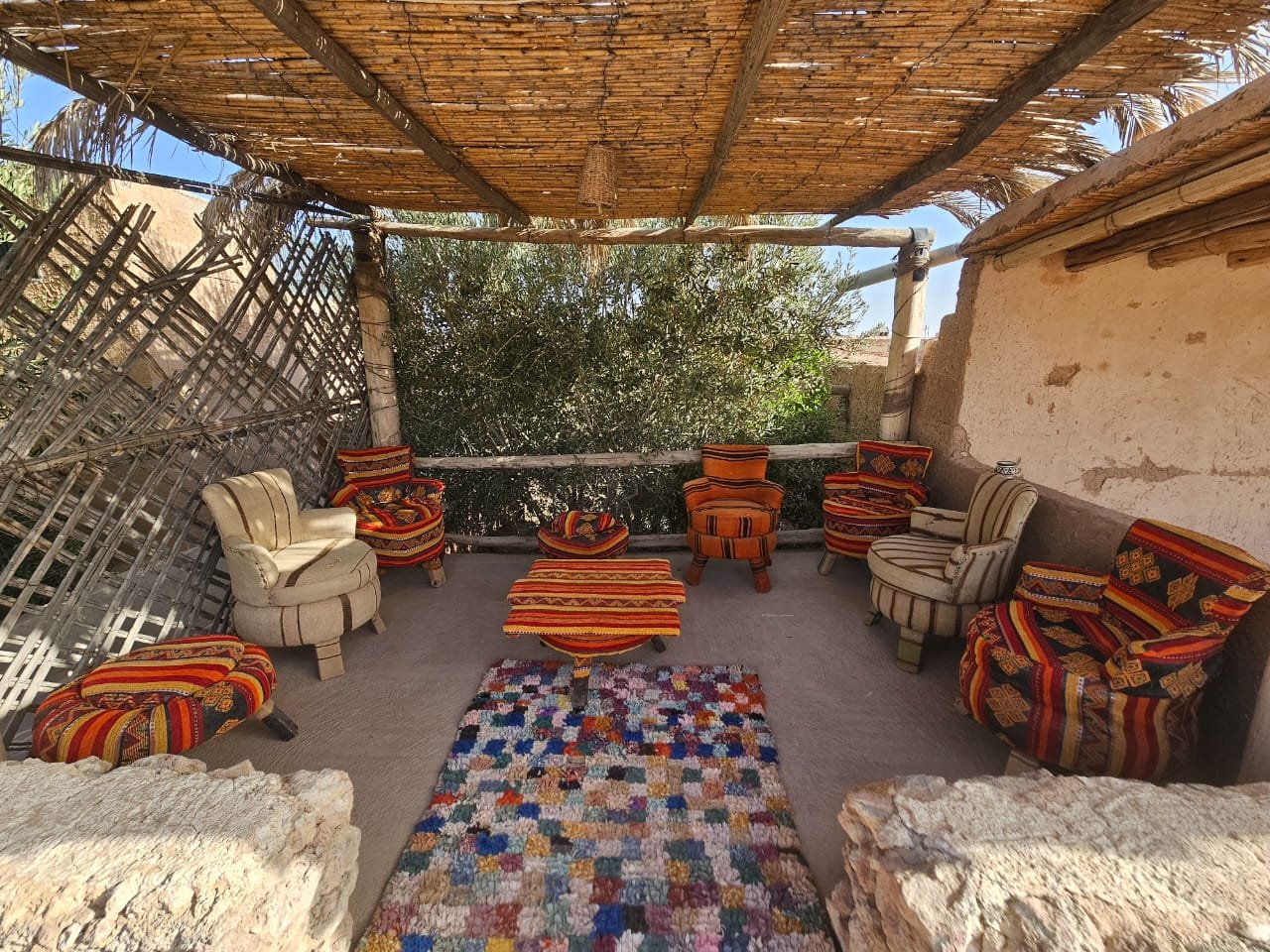 Shaded terrace with seating at the Agafay desert camp
